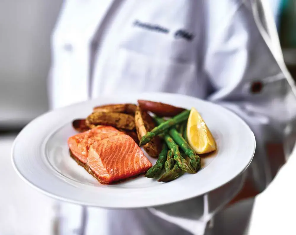 Willow Creek Chef Created Meals, chef delivering a finished dish.