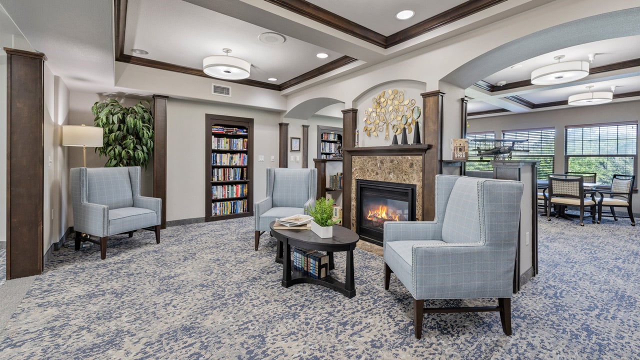 The library at Willow Creek with shelves of books and comfortable seating